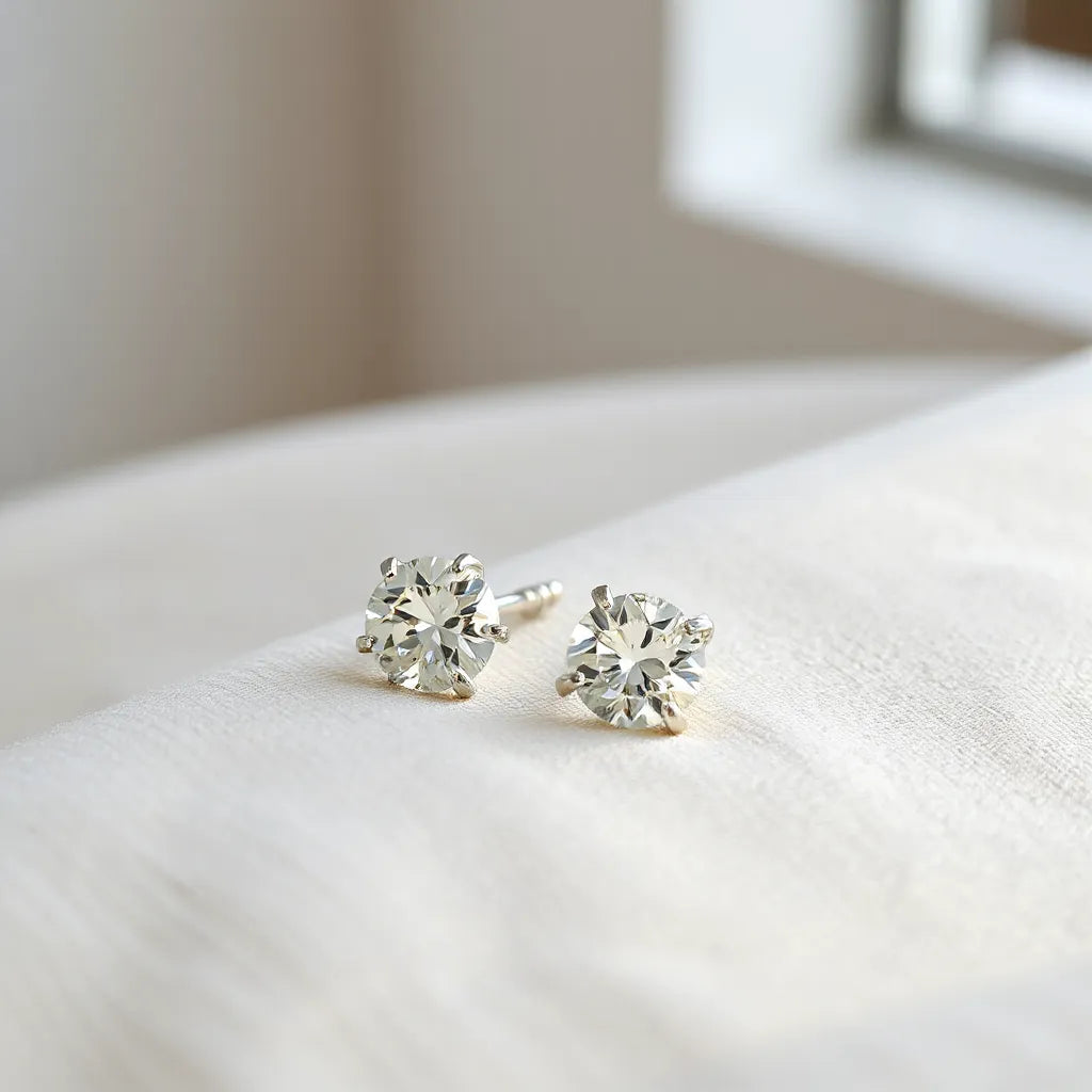 Pair of zirconia earrings with visible stone facets and polished settings on a neutral background