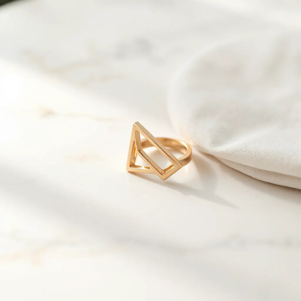 Asymmetrical geometric fashion ring with angular design on a neutral background under soft natural light
