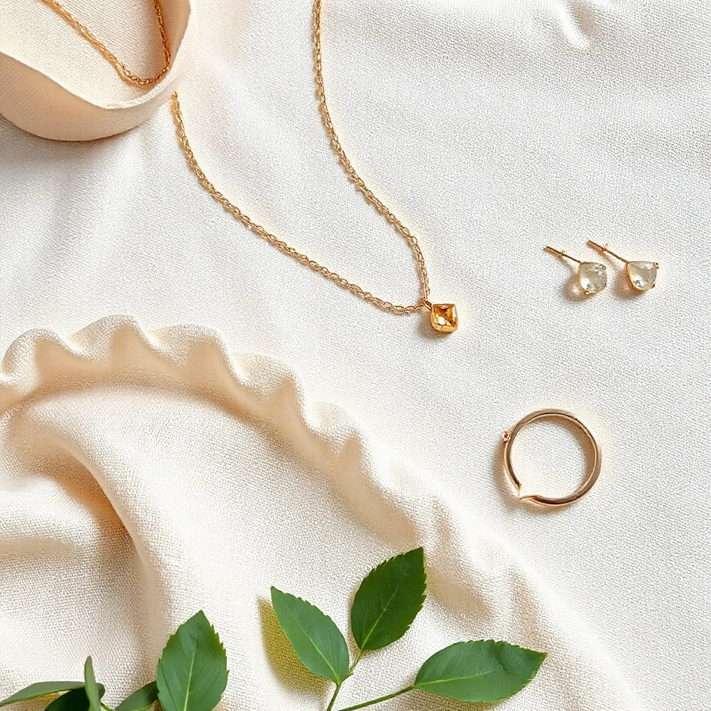 Elegant necklace, earrings, bracelet, and ring arranged on neutral fabric for a special occasion look