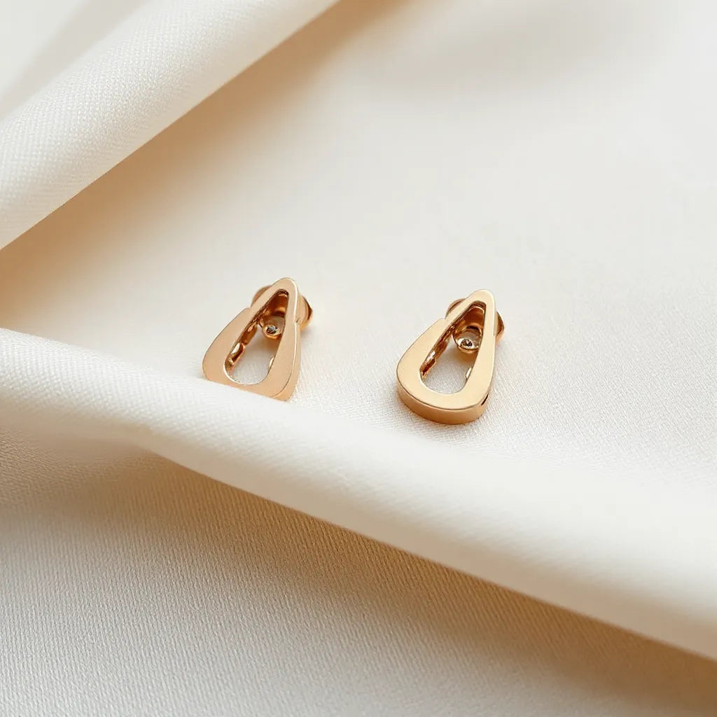 Pair of clip earrings with visible clasp, laid on neutral fabric in soft natural light